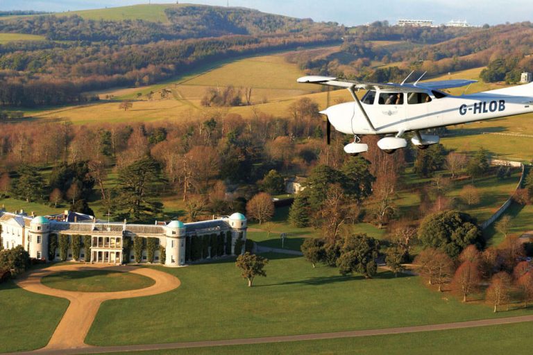 Photo of a plane flying over Goodwood House 